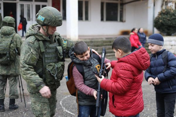 Мальчишки рассматривают оружие российского миротворца во дворе школы в Степанакерте - Sputnik Армения