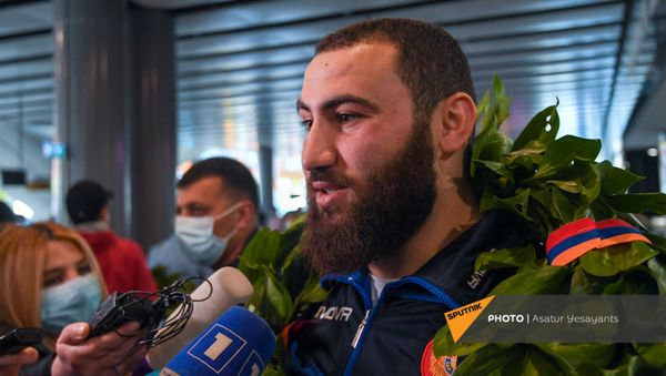 Завоевавший малое золото на Чемпионате Европы 2021 по тяжелой атлетике Симон Мартиросян отвечает на вопросы журналистов в аэропорту Звартноц (12 апреля 2021). Еревaн - Sputnik Армения