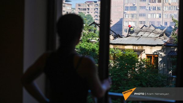 Проживающий по соседству гражданин наблюдает за действиями спасателей на месте пожара на улице Сарьяна (18 мая 2021). Еревaн - Sputnik Արմենիա