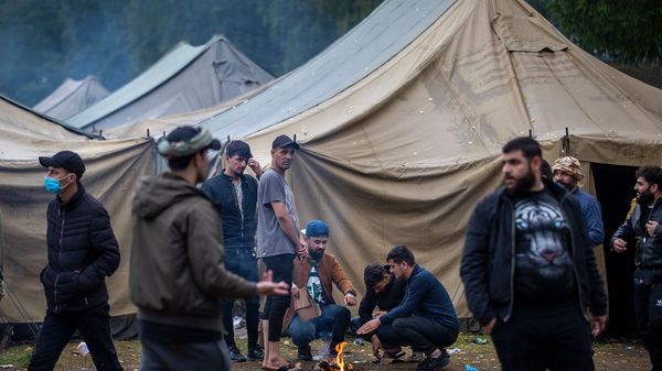 Мигранты готовят еду в недавно построенном лагере беженцев на военном полигоне Руднинкай (6 августа 2021). Литва - Sputnik Армения