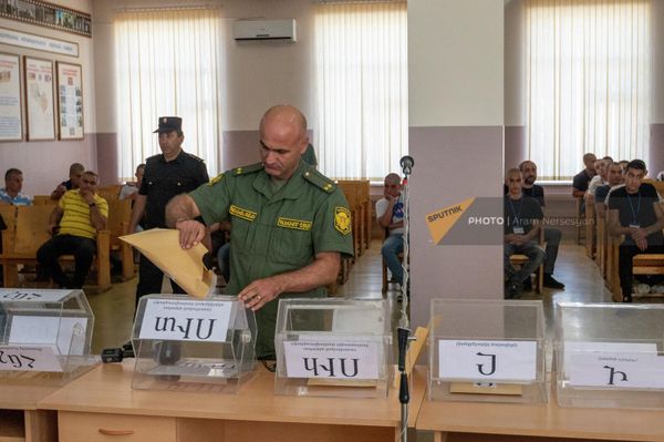 Офицер комиссии заполняет барабаны перед началом жеребьевки новобранцев в Республиканском сборном пункте (28 июня 2022). Еревaн - Sputnik Армения