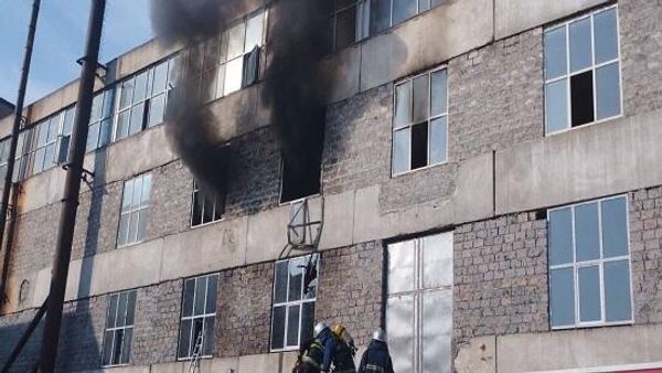 Дым виден из окон кофейной фабрики, расположенной по адресу ул. Севана 86/1 (16 октября 2022). Еревaн - Sputnik Армения