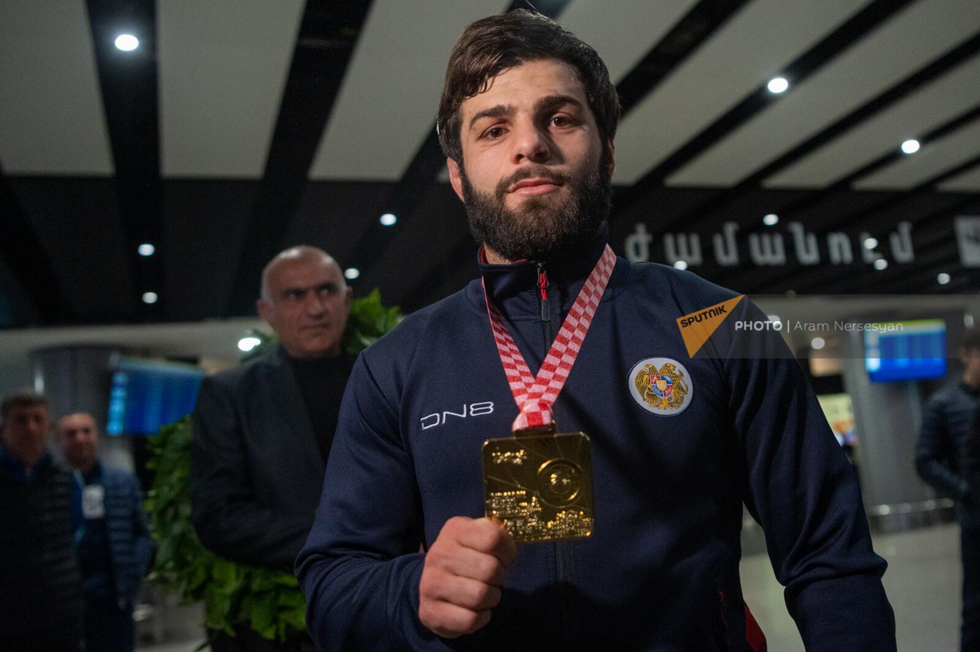 Чемпион Европы по вольной борьбе Вазген Теванян  показывает свою золотую медаль в аэропорту Звартноц по возвращении на родину (21 апреля 2023). Еревaн - Sputnik Армения, 1920, 21.04.2023