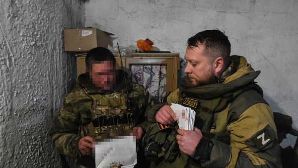 Военный корреспондент медиагруппы Россия сегодня Ростислав Журавлев (справа) раздает присланные письма для бойцов РФ в блиндаже на позициях в южном секторе спецоперации (12 февраля 2023).  - Sputnik Армения