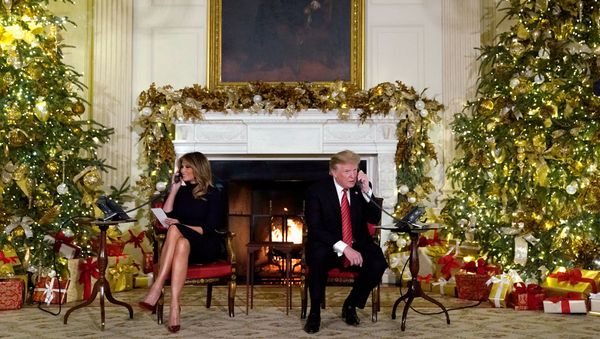 Президент США Дональд Трамп и первая леди Мелания Трамп участвуют в телефонных звонках NORAD Santa tracker из Белого дома (24 декабря 2018). Вашингтон - Sputnik Армения