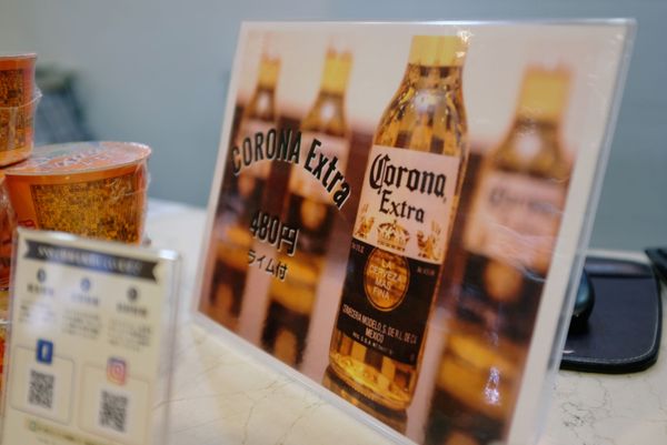 Вывеска с рекламой пива Corona со скидкой на стойке регистрации отеля Osaka Corona в Японии Вывеска с рекламой пива Corona со скидкой на стойке регистрации отеля Osaka Corona в Японии - Sputnik Армения