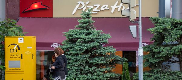 Женщины проходят мимо пиццерии Pizza Hut - Sputnik Армения